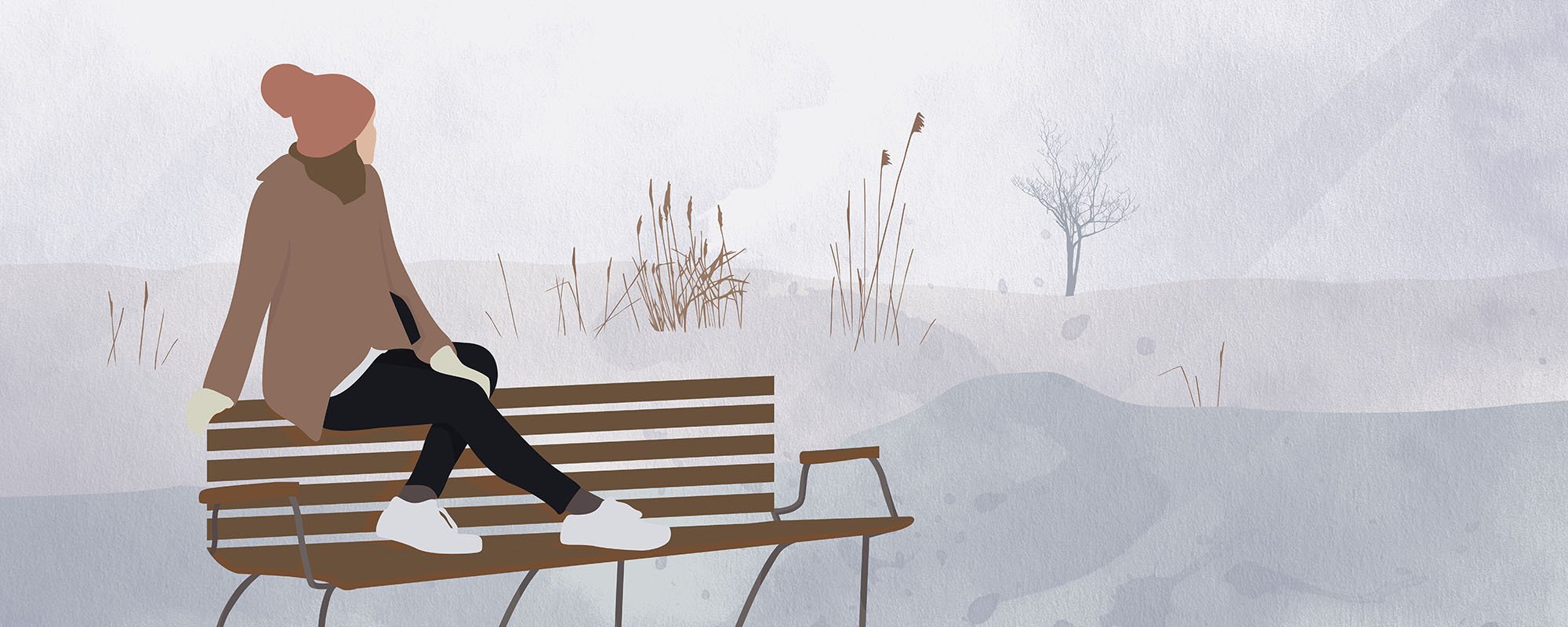Nainen istuu penkillä talvimaisemassa